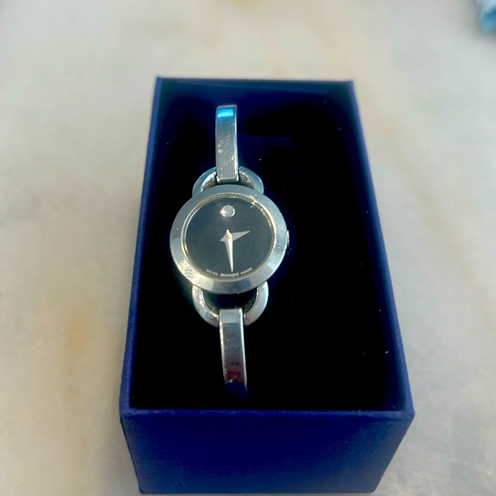 Women’s silver Movado watch with a black face dainty watch with a diamond